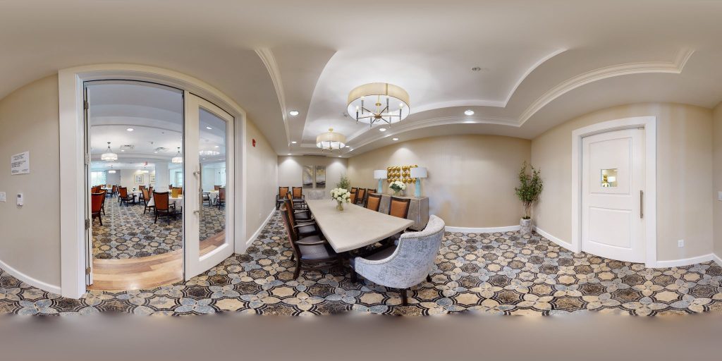 Elegant conference room with a long table, chairs, and decorative lighting.
