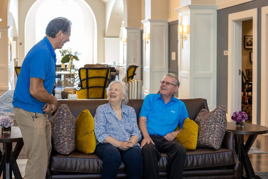 man chatting to couple
