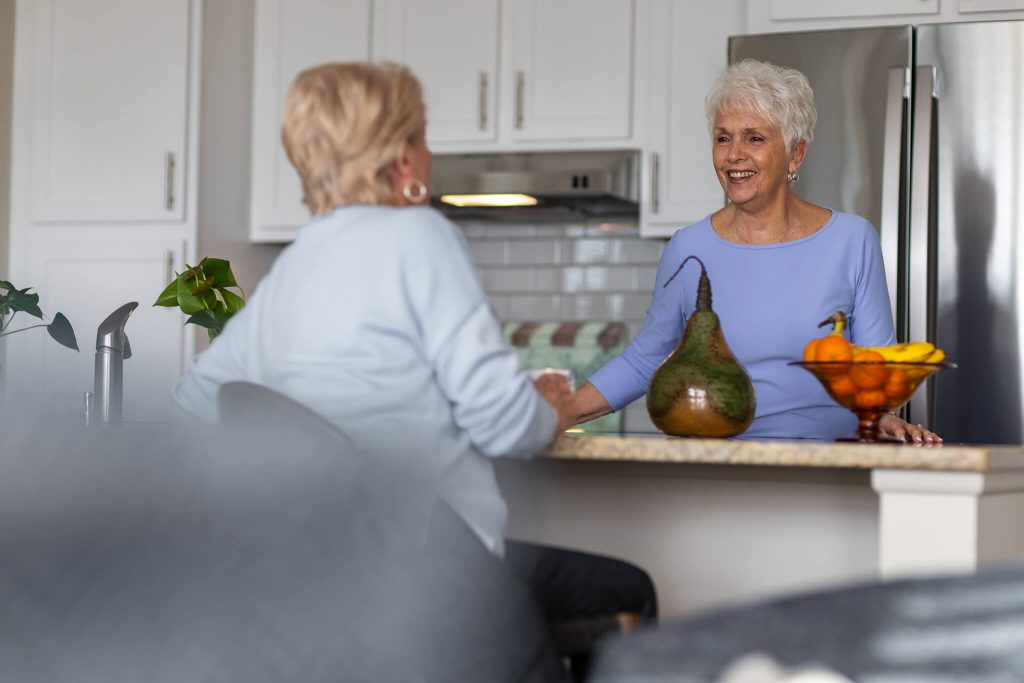 women chatting in kitchen