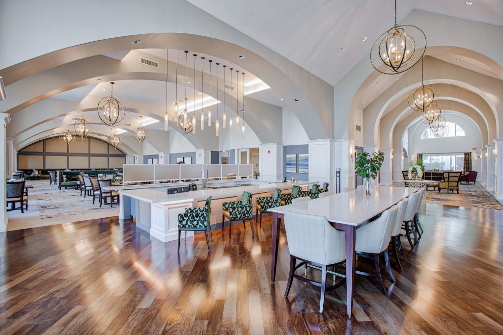 Spacious communal area with wooden floors, modern lighting, and comfortable seating.