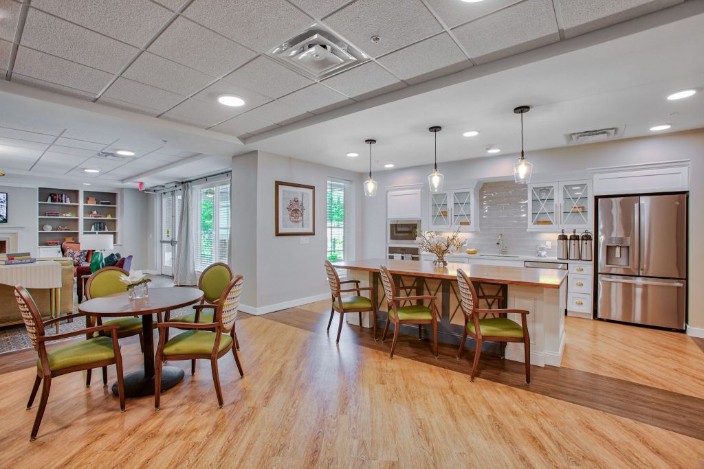 Spacious communal kitchen with seating and living area, featuring modern design elements.