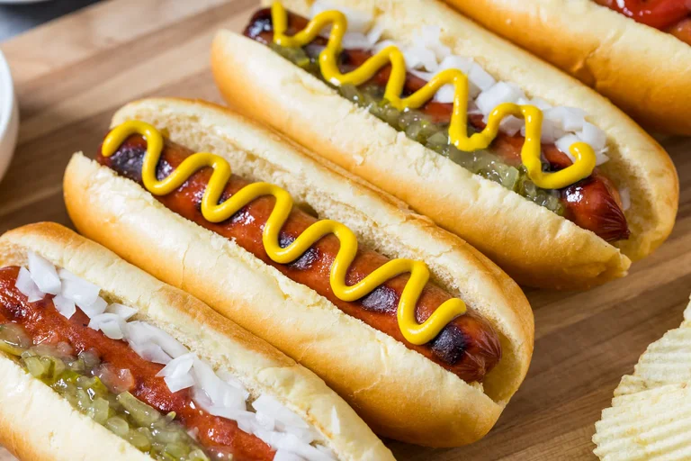 hot dogs with various toppings in a line